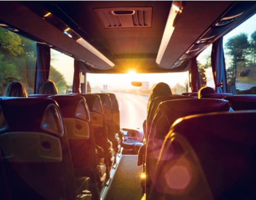 the interior of a coach bus on the road